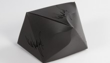 Black asymmetrical box with logotypes.